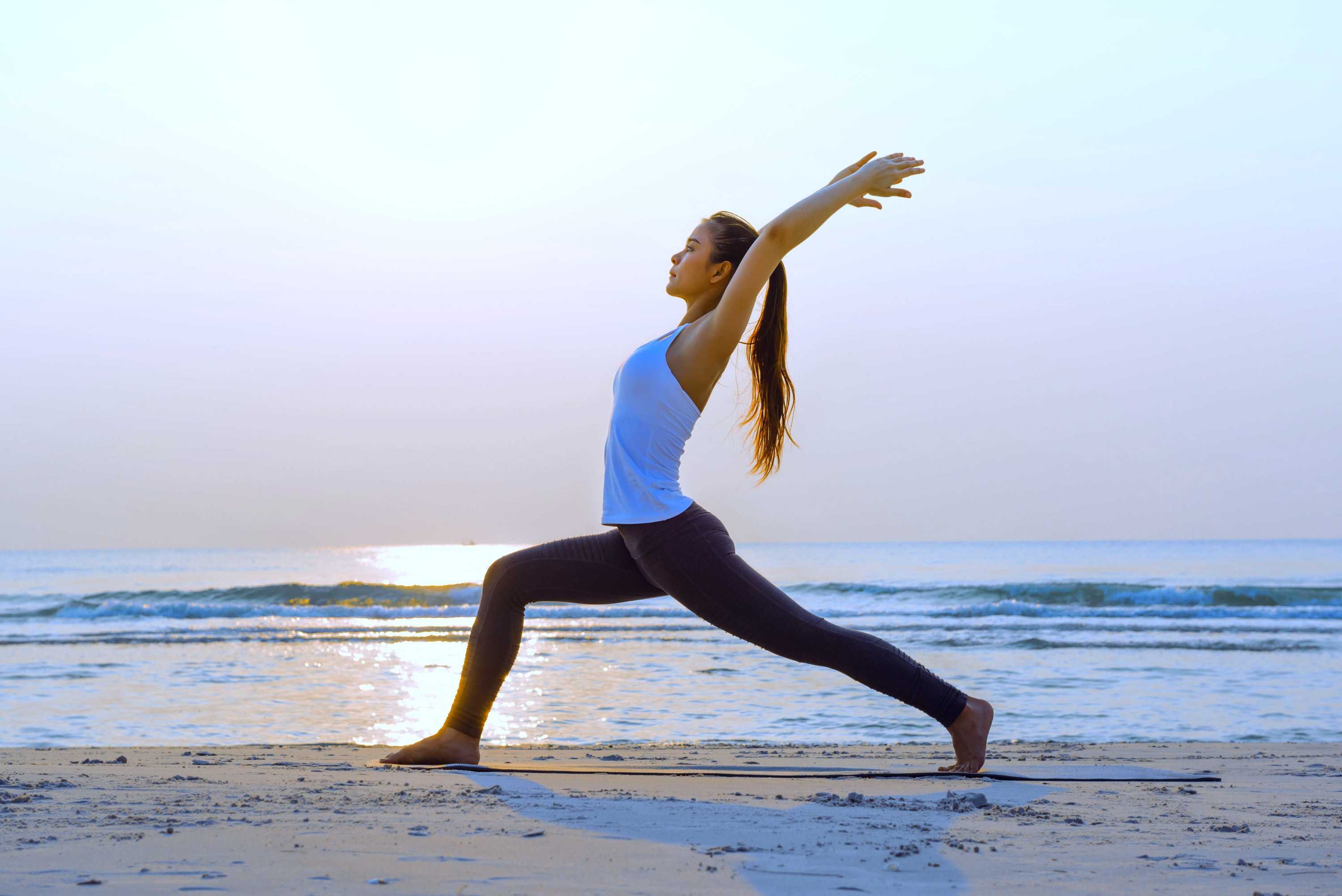 An image of someone stretching on a beach